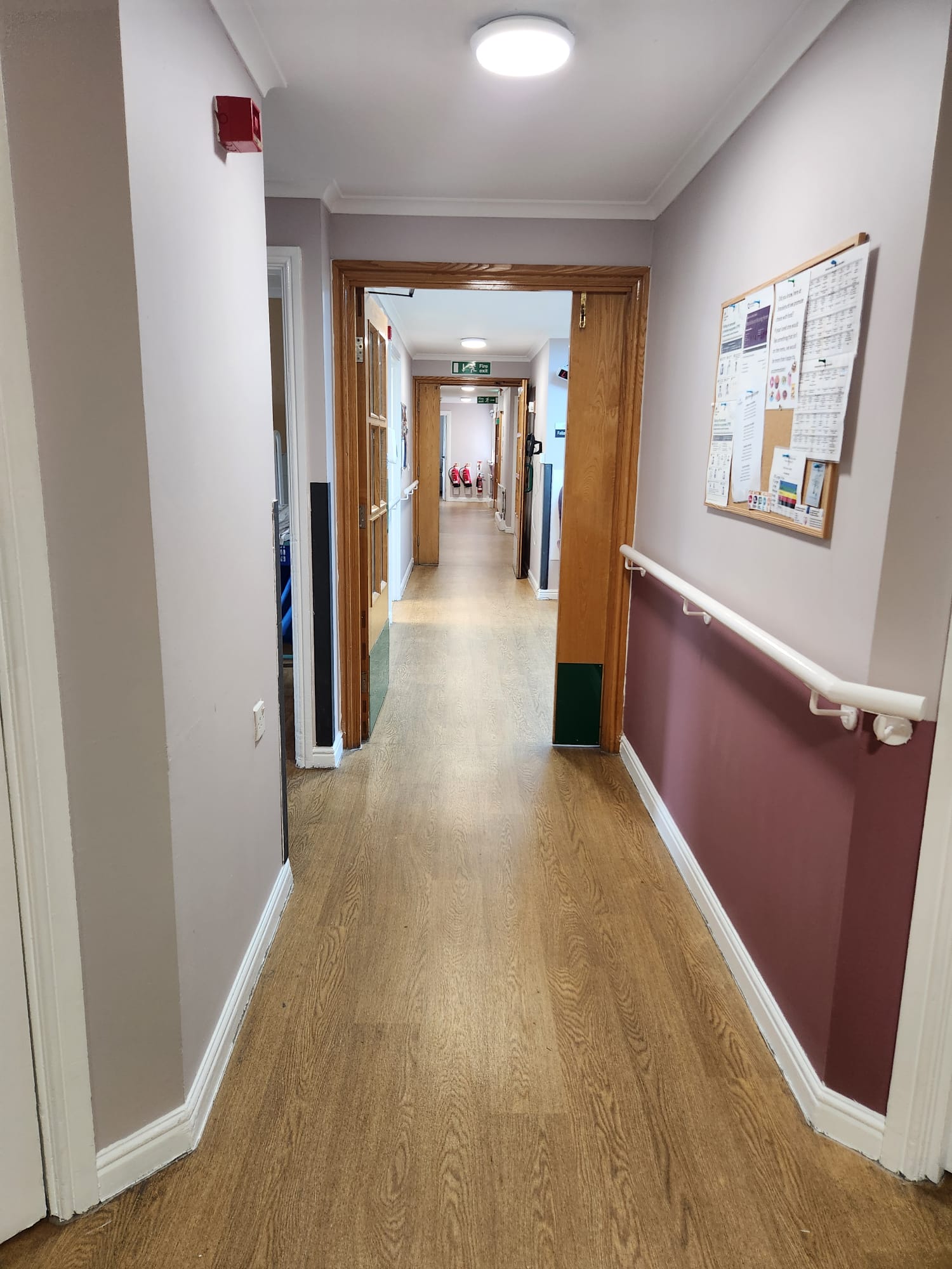 Finished corridor with a rich maroon lower wall