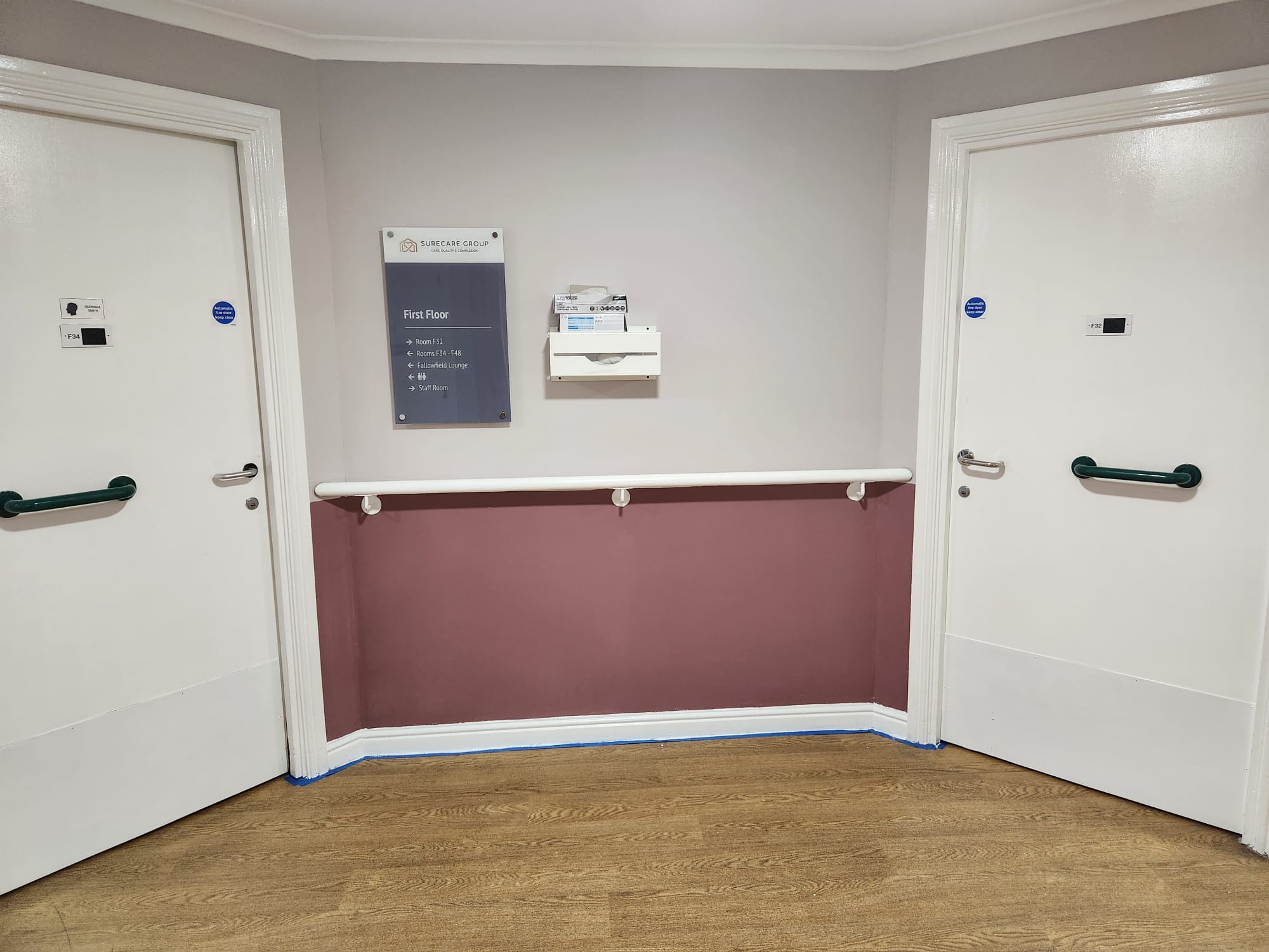 Finished maroon feature wall between two doors